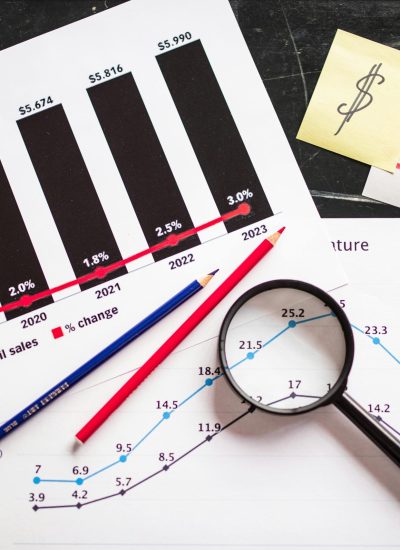 pexels-photo-7947758-7947758 Charts and graphs highlighting retail sales growth, utilizing a magnifying glass for detail.